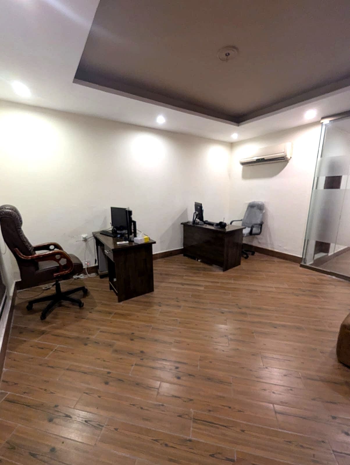 Dedicated desks with monitors and ergonomic chairs